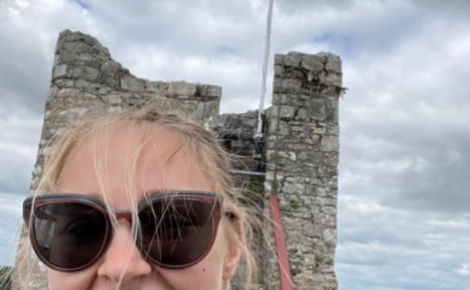 Photo of Taylor Fennelly in front of a castle in Ireland
