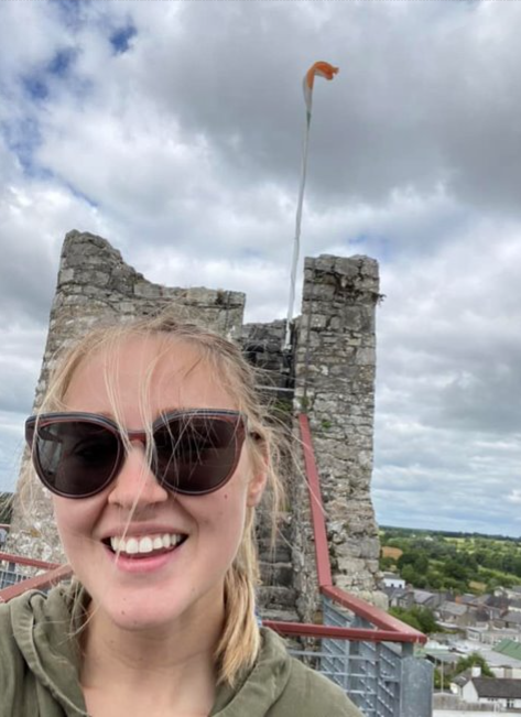 Photo of Taylor Fennelly in front of a castle in Ireland